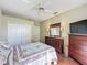 Bedroom featuring wood floors, a ceiling fan, and a queen-size bed at 3559 Chapel Hill Blvd, Clermont, FL 34711