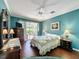 Cozy bedroom featuring hardwood floors, ceiling fan, and sliding glass door to the outside at 3559 Chapel Hill Blvd, Clermont, FL 34711