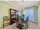 Traditional dining room featuring a dark wood table, elegant china cabinet, and chandelier lighting at 3559 Chapel Hill Blvd, Clermont, FL 34711
