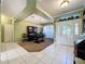 Spacious foyer with tile floors, decorative glass front door, and hutch with dining area in view at 3559 Chapel Hill Blvd, Clermont, FL 34711