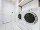 Laundry room featuring a stacked washer and dryer and white cabinets at 3559 Chapel Hill Blvd, Clermont, FL 34711