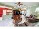 Open-concept living room featuring tile floors, a ceiling fan, and a view into the kitchen at 3559 Chapel Hill Blvd, Clermont, FL 34711