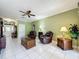 Comfortable living room with tile floors, ceiling fan, and a view of the front entry at 3559 Chapel Hill Blvd, Clermont, FL 34711