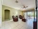 Spacious living room with tile flooring, ceiling fan, and sliding glass doors to the patio at 3559 Chapel Hill Blvd, Clermont, FL 34711
