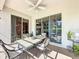 Covered outdoor patio dining area with table, seating, ceiling fan and sliding glass doors at 3559 Chapel Hill Blvd, Clermont, FL 34711