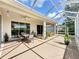 Relaxing screened patio features a ceiling fan, dining table, and hot tub for outdoor enjoyment at 3559 Chapel Hill Blvd, Clermont, FL 34711
