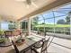 Covered and screened patio with outdoor dining area and hot tub overlooking a golf course at 3559 Chapel Hill Blvd, Clermont, FL 34711