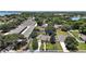 Stunning aerial view of a property with a pool and manicured lawn surrounded by lush greenery and a lake nearby at 397 Anderson Dr, Tavares, FL 32778