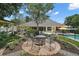 Inviting backyard features a fire pit, comfortable seating, and meticulously landscaped grounds for outdoor enjoyment at 397 Anderson Dr, Tavares, FL 32778