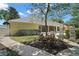 Landscaped backyard featuring a patio and manicured garden, offering a serene outdoor living space at 397 Anderson Dr, Tavares, FL 32778