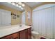 Bathroom showcasing a vanity with a marble countertop, and a shower with bathtub and curtain at 397 Anderson Dr, Tavares, FL 32778