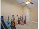 Neutral bedroom featuring a ceiling fan and filled with musical instruments, ideal for hobbyists or musicians at 397 Anderson Dr, Tavares, FL 32778