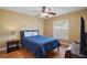 Bedroom with hardwood floors and a blue bed, showcasing comfort and style at 397 Anderson Dr, Tavares, FL 32778