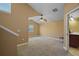 Spacious carpeted bedroom with a ceiling fan, window, and neutral paint, creating a comfortable retreat at 397 Anderson Dr, Tavares, FL 32778