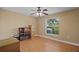 Bedroom featuring wood floors, a ceiling fan, and a window overlooking the backyard at 397 Anderson Dr, Tavares, FL 32778