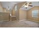 Bright bonus room with high ceilings, ceiling fans, carpet flooring, and staircase access, great for flexible living space at 397 Anderson Dr, Tavares, FL 32778