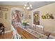 Spacious dining room with seating for six and staircase in the background at 397 Anderson Dr, Tavares, FL 32778