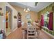 Bright dining room showcasing a long wooden table, white chairs, decorative accents, and large windows at 397 Anderson Dr, Tavares, FL 32778