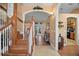 Bright foyer with hardwood floors and staircase leading to a hallway, creating an inviting entry at 397 Anderson Dr, Tavares, FL 32778