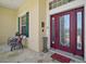 Inviting front entrance with a decorative glass door, stone floor porch and colorful flower boxes at 397 Anderson Dr, Tavares, FL 32778