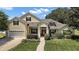 Charming single-Gathering home boasting a well-manicured lawn and two car garage at 397 Anderson Dr, Tavares, FL 32778