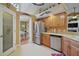 Bright kitchen with stainless appliances, wooden cabinets, and a pantry at 397 Anderson Dr, Tavares, FL 32778