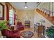 Cozy living room with hardwood floors, a staircase, and comfortable seating creating a welcoming ambiance at 397 Anderson Dr, Tavares, FL 32778