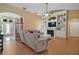 Spacious living room featuring hardwood floors, a fireplace, and built-in shelving perfect for entertaining and relaxation at 397 Anderson Dr, Tavares, FL 32778