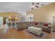 Open-concept living room flowing into the kitchen, featuring hardwood floors and comfortable, plush seating at 397 Anderson Dr, Tavares, FL 32778