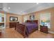 This traditional main bedroom features a wood sleigh bed, hardwood floors, and recessed lighting at 397 Anderson Dr, Tavares, FL 32778