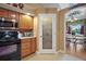 View of the pantry in the kitchen, next to stove with dining room in background at 397 Anderson Dr, Tavares, FL 32778