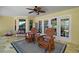 Charming covered patio with comfortable seating, perfect for enjoying outdoor relaxation and entertaining guests at 397 Anderson Dr, Tavares, FL 32778