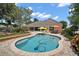 Backyard swimming pool with lush landscaping, patios, and ample seating, creating a perfect outdoor oasis at 397 Anderson Dr, Tavares, FL 32778