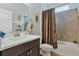 Cozy bathroom with dark wood vanity, white countertop, tub and shower combination, and tiled walls at 4581 Shenandoah River Trl, Leesburg, FL 34748