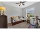 Well-lit bedroom featuring a daybed with drawers, a ceiling fan, and fitness equipment at 4581 Shenandoah River Trl, Leesburg, FL 34748