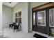 Inviting front porch with seating area and decorative glass door, perfect for welcoming guests at 4581 Shenandoah River Trl, Leesburg, FL 34748