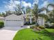 Charming single-story home featuring a manicured lawn, a two-car garage, and a welcoming front porch at 4581 Shenandoah River Trl, Leesburg, FL 34748