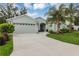 Attractive single-story home with a two-car garage, a well-kept lawn, and mature landscaping at 4581 Shenandoah River Trl, Leesburg, FL 34748
