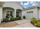 Close up view of the home's entrance, highlighting the covered porch, columns, and landscaping at 4581 Shenandoah River Trl, Leesburg, FL 34748