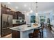 Spacious kitchen featuring a large island with bar seating and stainless steel appliances at 4581 Shenandoah River Trl, Leesburg, FL 34748