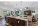 Open kitchen and living area featuring a large island and seamless entertaining space at 4581 Shenandoah River Trl, Leesburg, FL 34748