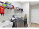 Functional laundry room features a washer, dryer, sink, shelving and storage cabinets at 4581 Shenandoah River Trl, Leesburg, FL 34748