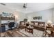 Inviting living room with leather furniture and a dedicated workspace area at 4581 Shenandoah River Trl, Leesburg, FL 34748
