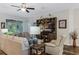 Comfortable living room with ceiling fan and large TV, perfect for relaxation at 4581 Shenandoah River Trl, Leesburg, FL 34748