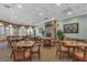 Dining area featuring tables, chairs, natural light, and a fireplace at 4581 Shenandoah River Trl, Leesburg, FL 34748