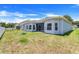 View of the spacious backyard featuring healthy green grass and an attractive blue swing set at 4716 Block Island Ln, Clermont, FL 34714