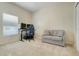 Versatile room with neutral tones, suitable as a bedroom or office, featuring comfortable seating at 4716 Block Island Ln, Clermont, FL 34714