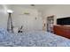 Bright bedroom with a comfortable bed, closet, and desk, offering a cozy and functional space at 4716 Block Island Ln, Clermont, FL 34714