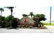 Attractive stone community entrance sign for Tradd's Landing, enhanced by palm trees and landscaping at 4716 Block Island Ln, Clermont, FL 34714