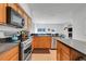 Open kitchen featuring modern appliances, a center island, and ample counter space with tile flooring at 4716 Block Island Ln, Clermont, FL 34714